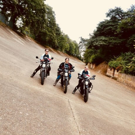 a photo of three people on motorbikes