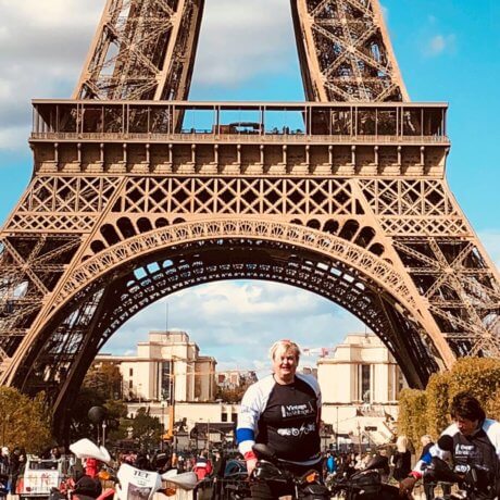 a photo of people on motorbikes in front of the Eiffel Tower