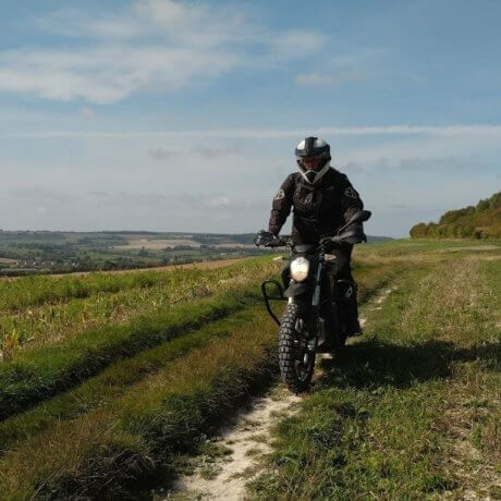 a photo of a person on a bike in a field
